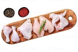 Chicken parts arranged on a wooden board